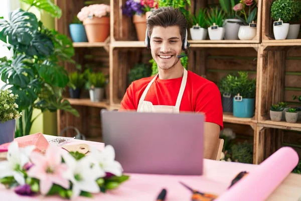 Young hispanic man working at florist shop doing video call happy face smiling with crossed arms looking at the camera. positive person. 