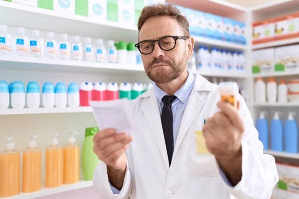 Homem Meia Idade Farmacêutico Segurando Pílulas Prescrição Leitura Garrafa Farmácia — Fotografia de Stock