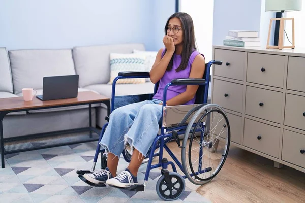 Young Hispanic Woman Sitting Wheelchair Home Looking Stressed Nervous Hands — Φωτογραφία Αρχείου