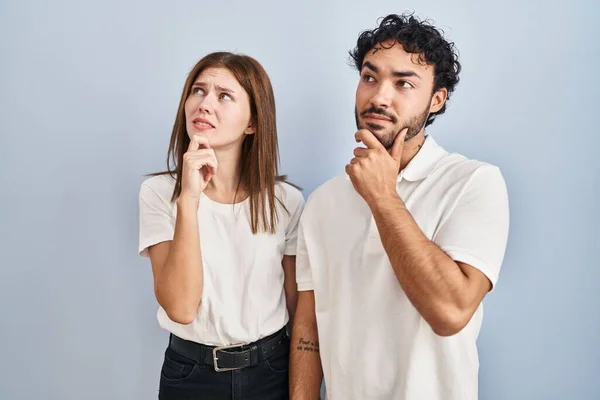 Young Couple Wearing Casual Clothes Standing Together Thinking Worried Question —  Fotos de Stock