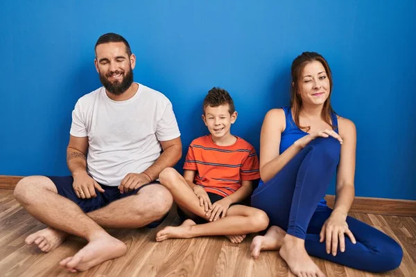 Family Three Sitting Floor Home Winking Looking Camera Sexy Expression — Stockfoto