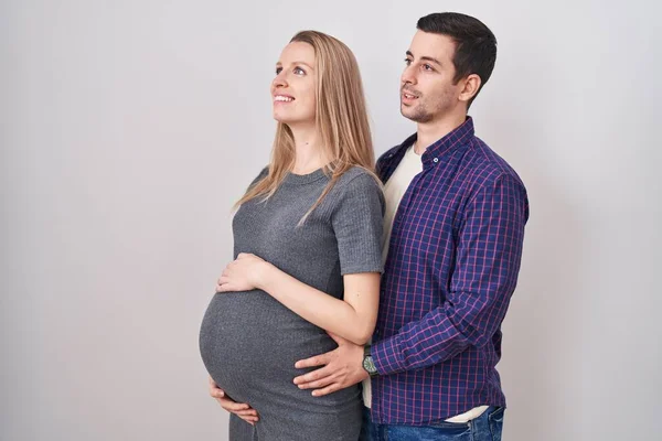 Young Couple Expecting Baby Standing White Background Looking Side Relax — Stock Photo, Image