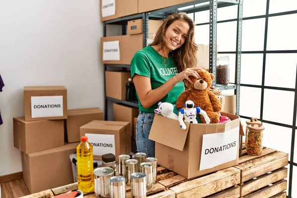 Young Beautiful Hispanic Woman Volunteer Holding Toys Donations Package Charity — Stock Photo, Image