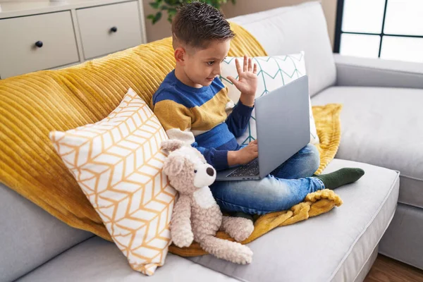 Adorable Hispanic Boy Having Video Call Sitting Sofa Home — Stok fotoğraf