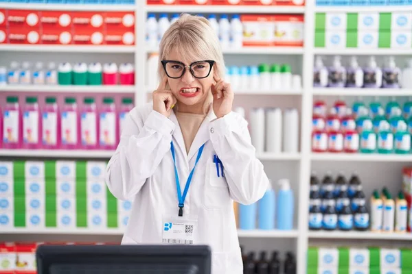 Young Caucasian Woman Working Pharmacy Drugstore Covering Ears Fingers Annoyed — Stock Photo, Image