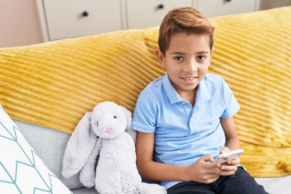 Adorable Hispanic Boy Using Smartphone Sitting Sofa Home — Stok fotoğraf
