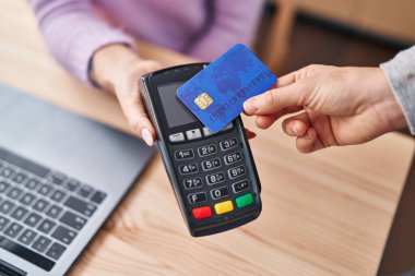 Young caucasian woman ecommerce business worker using credit card and data phone at office