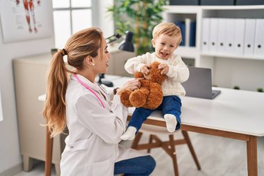 Mother and son having pediatrician consultation at clinic