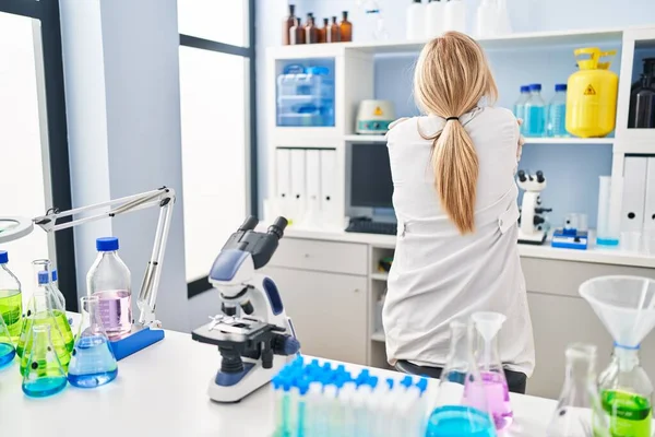 Middle Age Blonde Woman Working Scientist Laboratory Hugging Oneself Happy — Stock Photo, Image