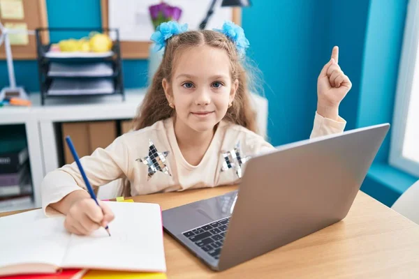 Young Little Girl Sitting Table Doing Homework Laptop Smiling Happy — Fotografia de Stock