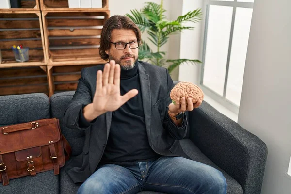 Handsome Middle Age Man Consultation Office Holding Brain Open Hand — Stock Fotó