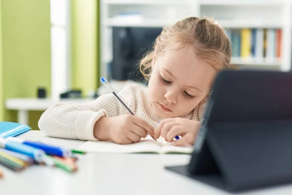 Adorable Blonde Girl Student Using Touchpad Writing Notebook Classroom — Foto Stock