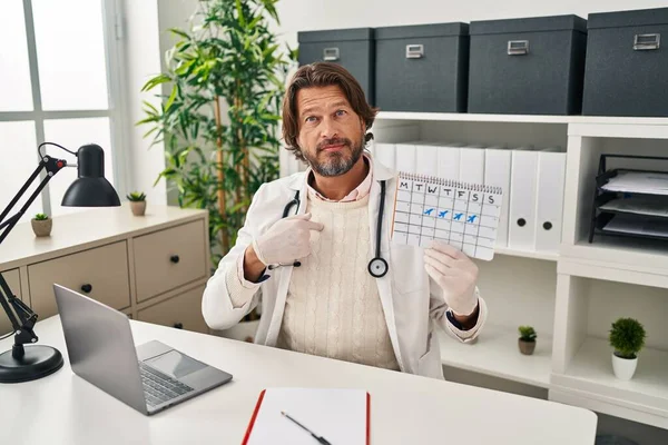 Handsome Middle Age Doctor Man Holding Holidays Calendar Pointing Finger — Stock Photo, Image