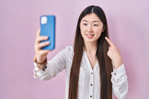 Chinese Young Woman Taking Selfie Photo Smartphone Smiling Happy Pointing — Stockfoto