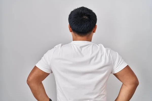Young Chinese Man Standing White Background Standing Backwards Looking Away — ストック写真