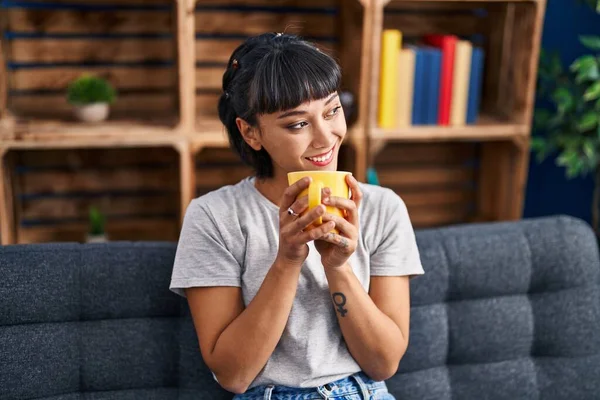 Young Woman Drinking Coffee Sitting Sofa Home — Stockfoto