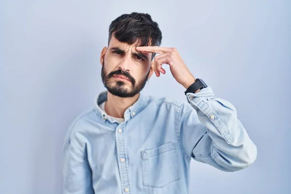 Young Hispanic Man Beard Standing Blue Background Pointing Unhappy Pimple — Stock Photo, Image
