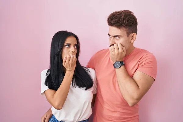 Young Hispanic Couple Standing Pink Background Looking Stressed Nervous Hands — стоковое фото