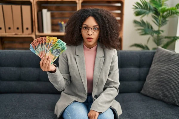 Young African American Woman Holding Australian Dollars Consultation Office Scared — Stockfoto