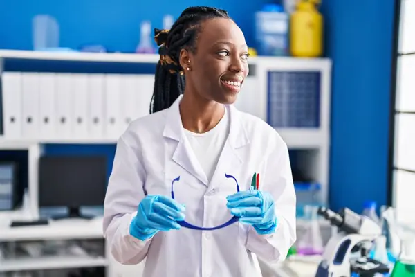 African American Woman Scientist Smiling Confident Holding Glasses Laboratory — Fotografia de Stock