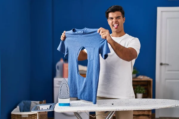 Hispanic Man Ironing Holding Burned Iron Shirt Laundry Room Sticking — Stockfoto