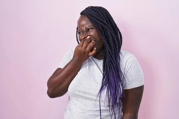 Young African Woman Standing Pink Background Smelling Something Stinky Disgusting — Stockfoto
