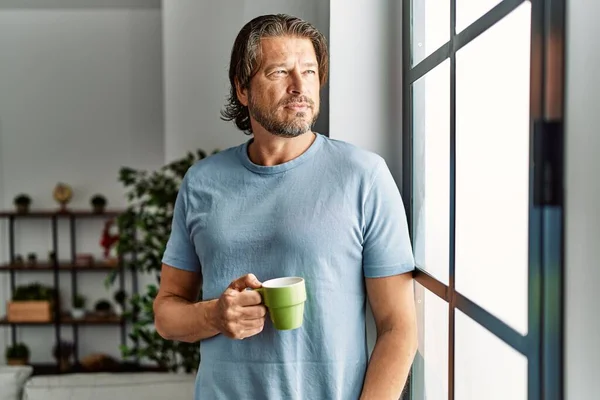 Middle Age Caucasian Man Drinking Coffee Leaning Window Home — Stock fotografie