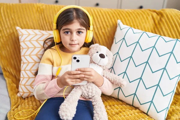 Adorable Hispanic Girl Listening Music Sitting Sofa Home — Stok fotoğraf