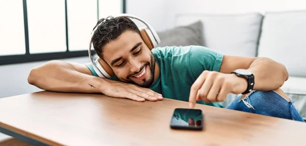 Young arab man smiling confident listening to music at home