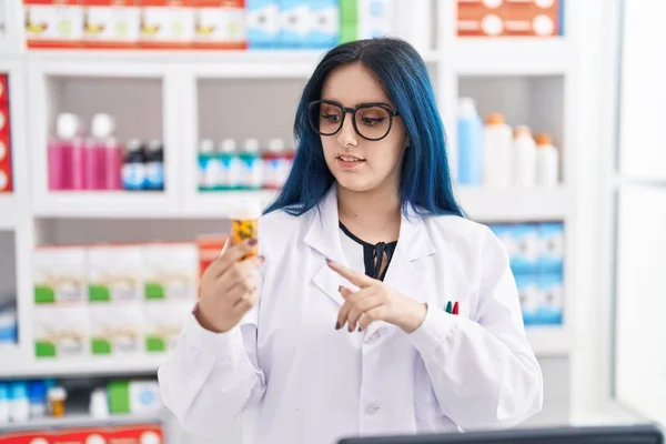 若い白人女性薬剤師が薬局で話す薬瓶を持っています — ストック写真