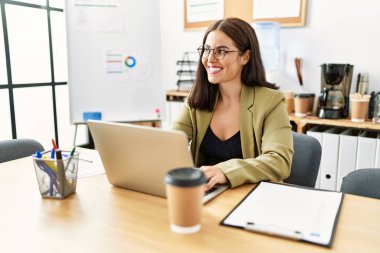 Young beautiful hispanic woman business worker using laptop working at office