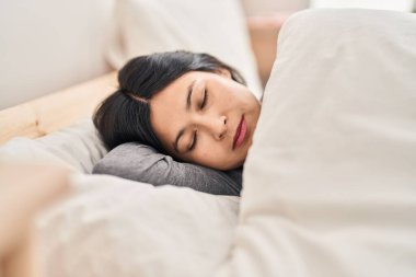 Young chinese woman lying on bed sleeping at bedroom