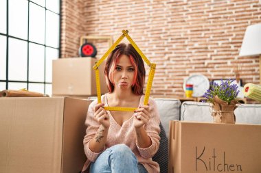 Young caucasian woman sitting on the sofa at new home depressed and worry for distress, crying angry and afraid. sad expression. 
