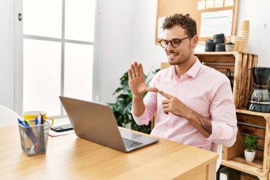 Ofisteki sağır işaret diliyle iletişim kuran Latin asıllı genç adam.