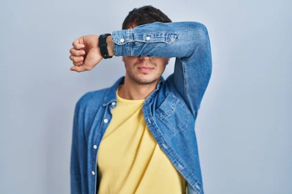 Young Hispanic Man Standing Blue Background Covering Eyes Arm Looking — Stock Photo, Image