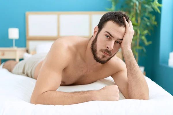 Young Hispanic Man Lying Bed Relaxed Expression Bedroom — ストック写真