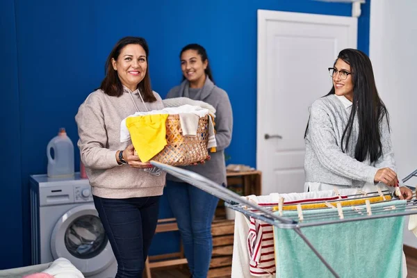 Three Woman Smiling Confident Hanging Clothes Clothesline Laundry Room — Foto de Stock
