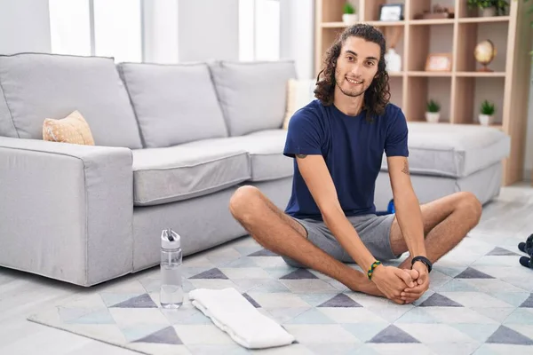 Young Hispanic Man Stretching Legs Sitting Floor Home — Stock Photo, Image