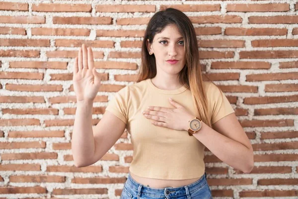 Young Brunette Woman Standing Bricks Wall Swearing Hand Chest Open — Stock Photo, Image