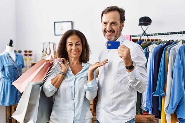 Hispanic Middle Age Couple Holding Shopping Bags Credit Card Smiling — Stockfoto