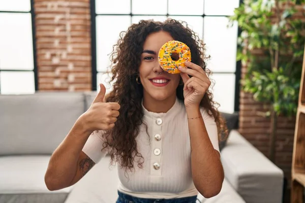 Young Hispanic Woman Holding Tasty Colorful Doughnut Eye Smiling Happy — Stockfoto