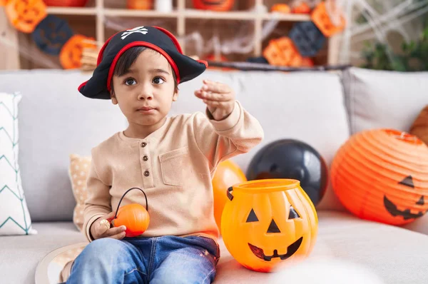 Adorable Hispanic Boy Having Halloween Party Holding Pumpkin Basket Home — Stock fotografie