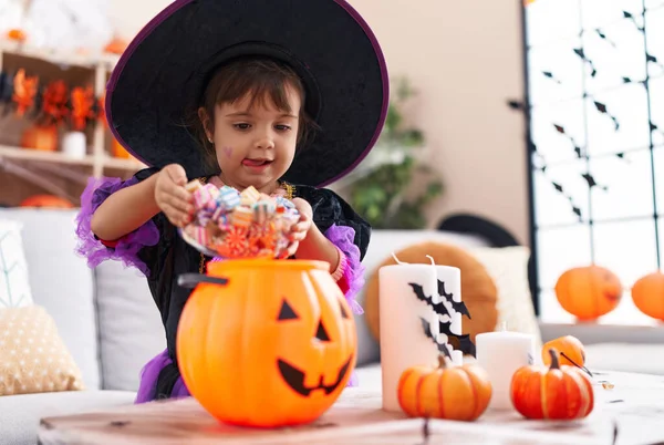 Adorable Hispanic Girl Having Halloween Party Putting Sweets Pumpkin Basket — Stock fotografie