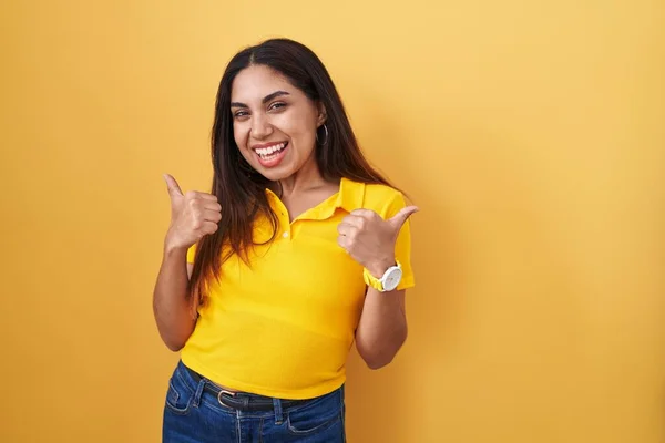 Young Arab Woman Standing Yellow Background Success Sign Doing Positive — Zdjęcie stockowe