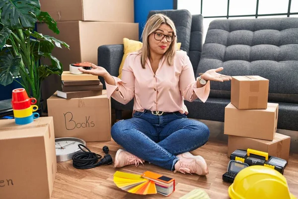 Young Hispanic Woman Moving New Home Sitting Floor Clueless Confused —  Fotos de Stock