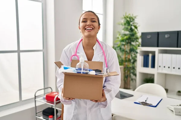 Young Hispanic Doctor Holding Box Medical Items Smiling Laughing Hard — Stock Photo, Image