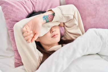 Chinese woman lying on bed crying at bedroom