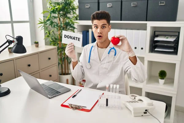 Young Hispanic Doctor Man Supporting Organs Donations Shock Face Looking — Photo