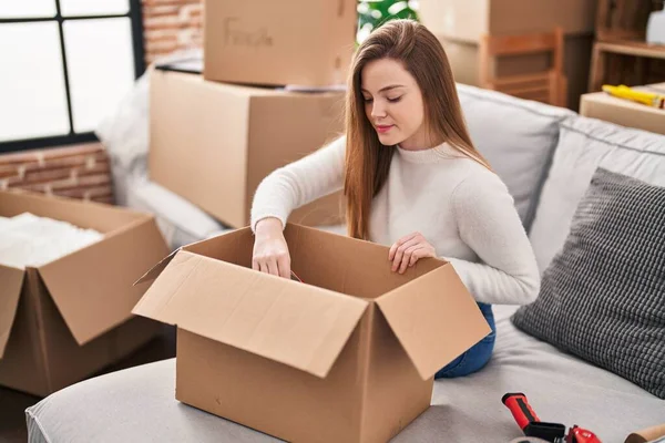 Young Blonde Woman Unboxing Package Sitting Sofa New Home — Stock Photo, Image
