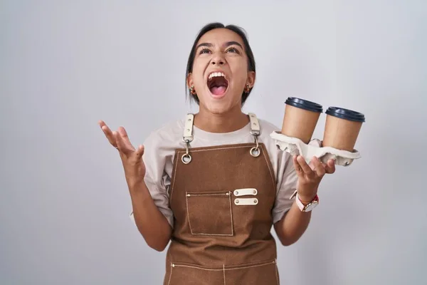 Young Hispanic Woman Wearing Professional Waitress Apron Holding Coffee Crazy — Zdjęcie stockowe